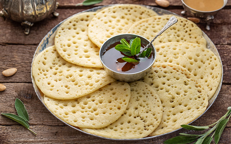 Close view of Morrocan pancakes Baghrir with honey
