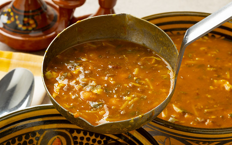 Serving Moroccan harira soup close up
