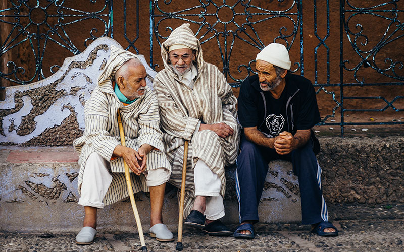 A couple of men chatting in Chefchaouen's main square
